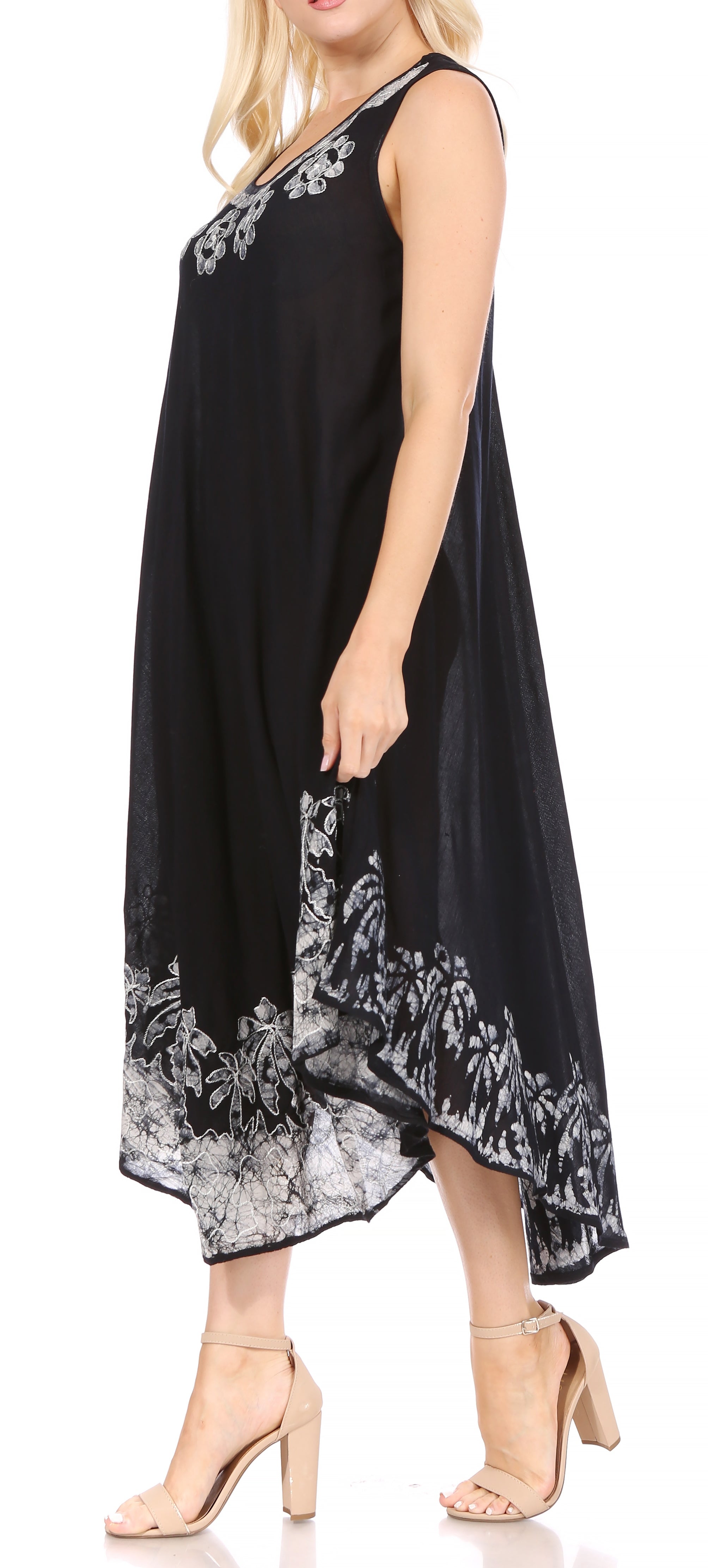 Black dress with white lace details worn by a model on a white background