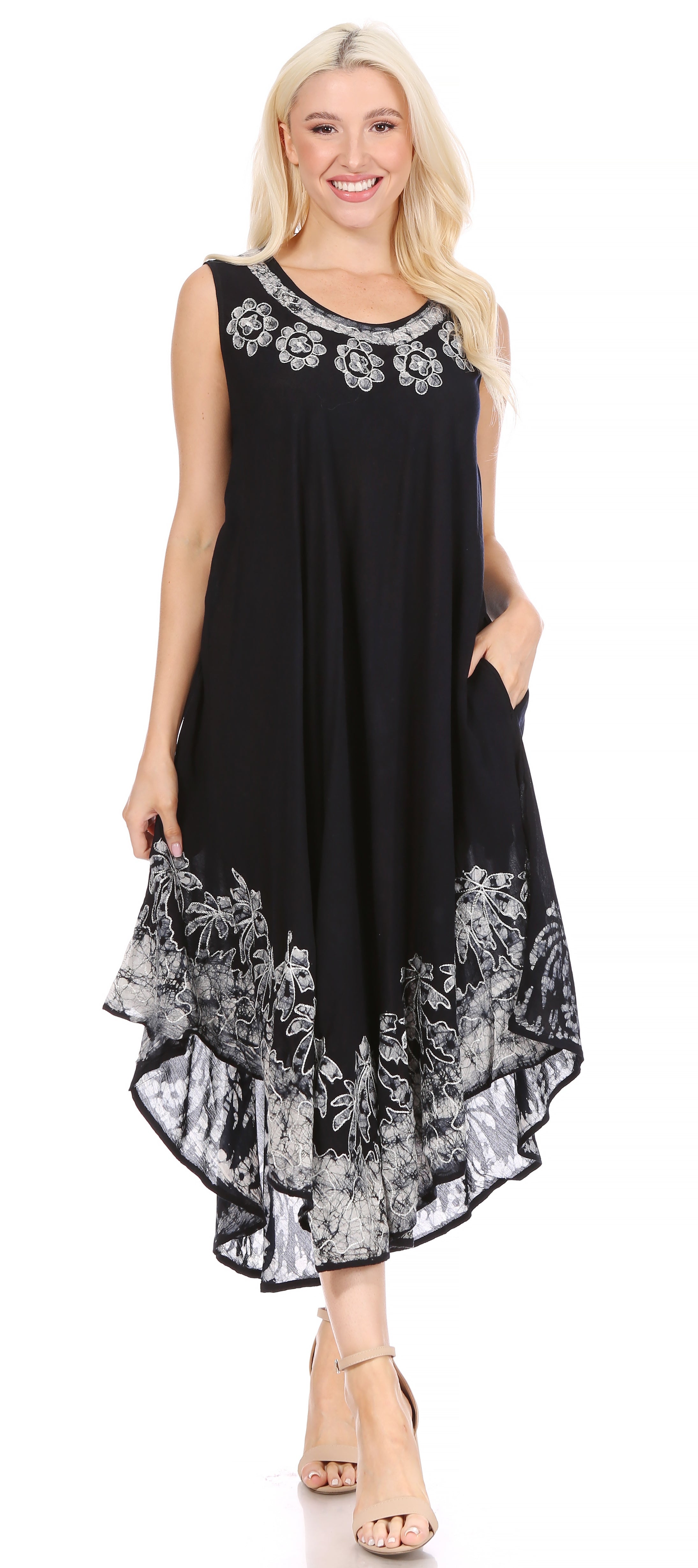 Woman wearing a black sleeveless dress with floral patterns on a white background