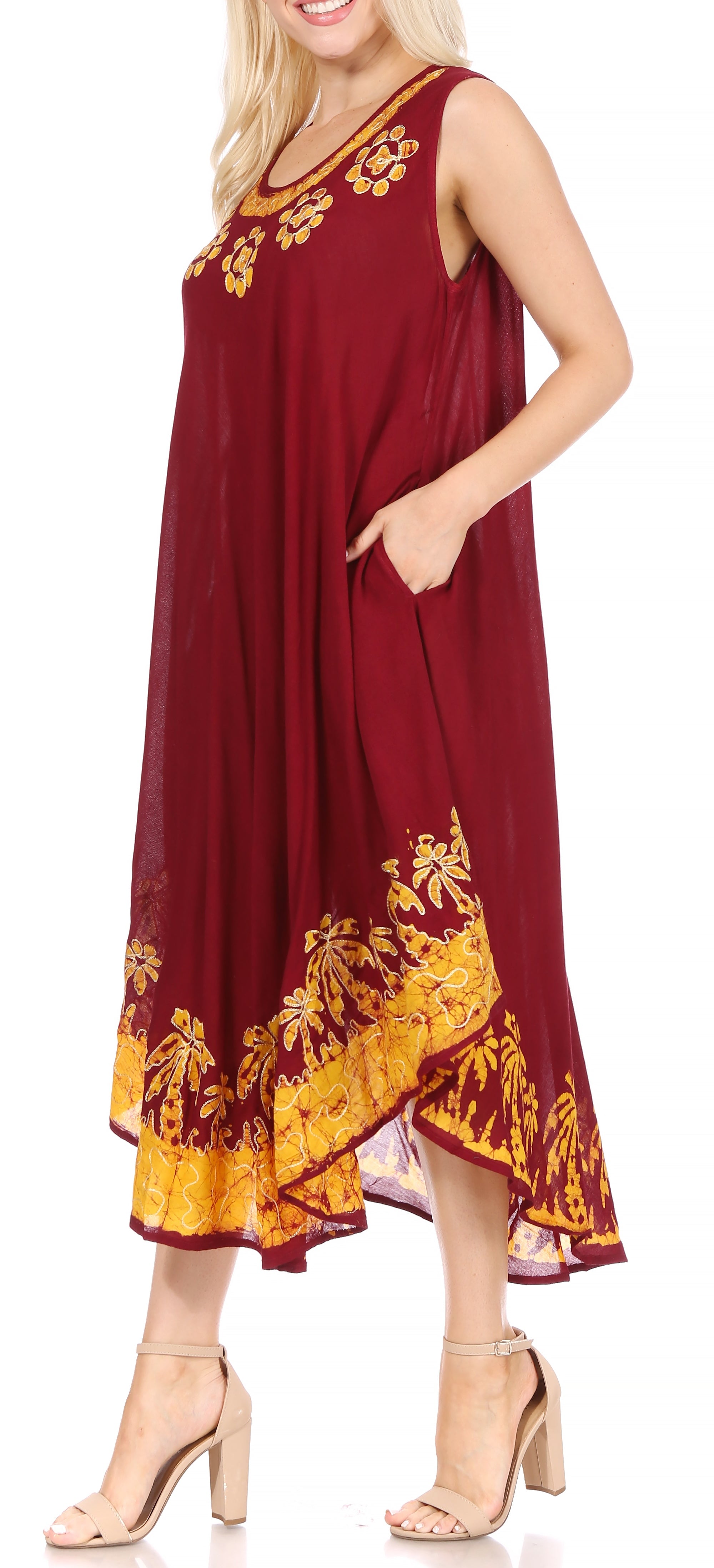 Woman wearing a burgundy dress with yellow floral patterns on a white background