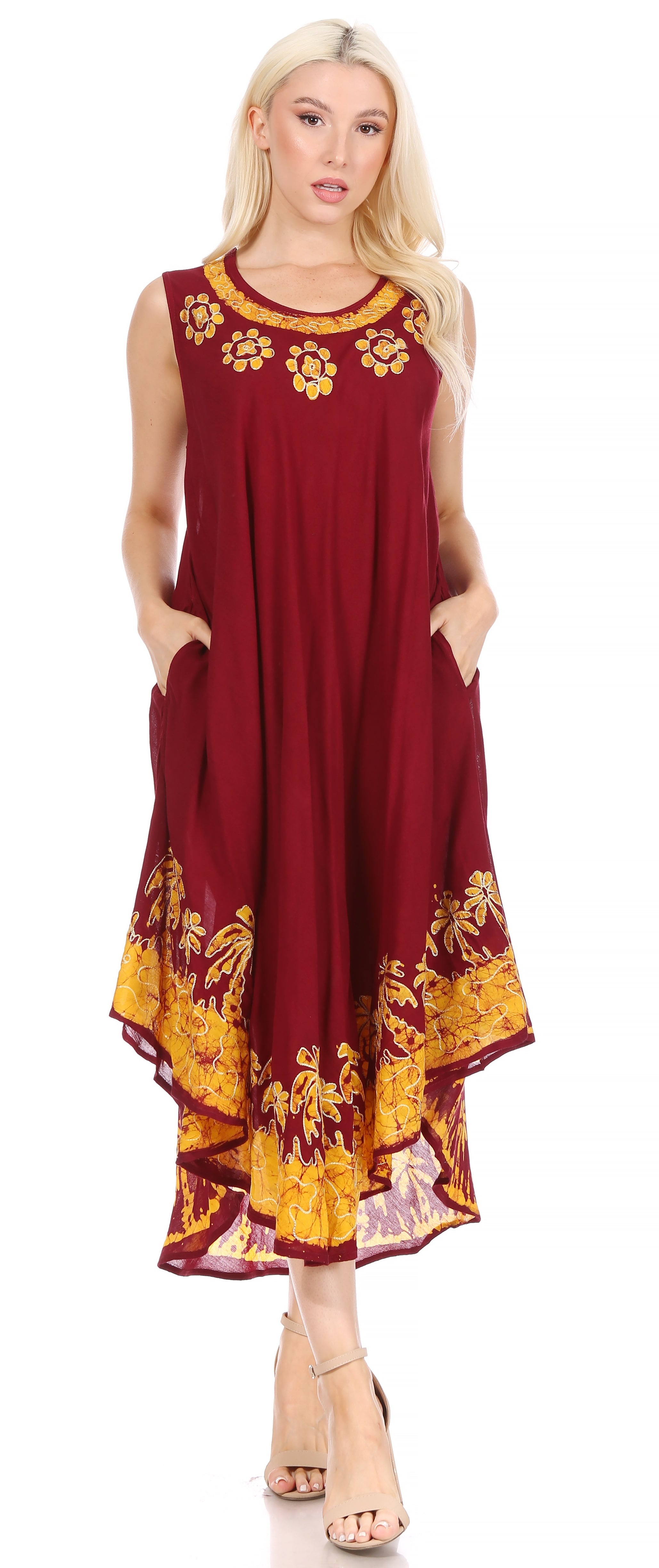 Woman wearing a burgundy and yellow floral dress on a white background