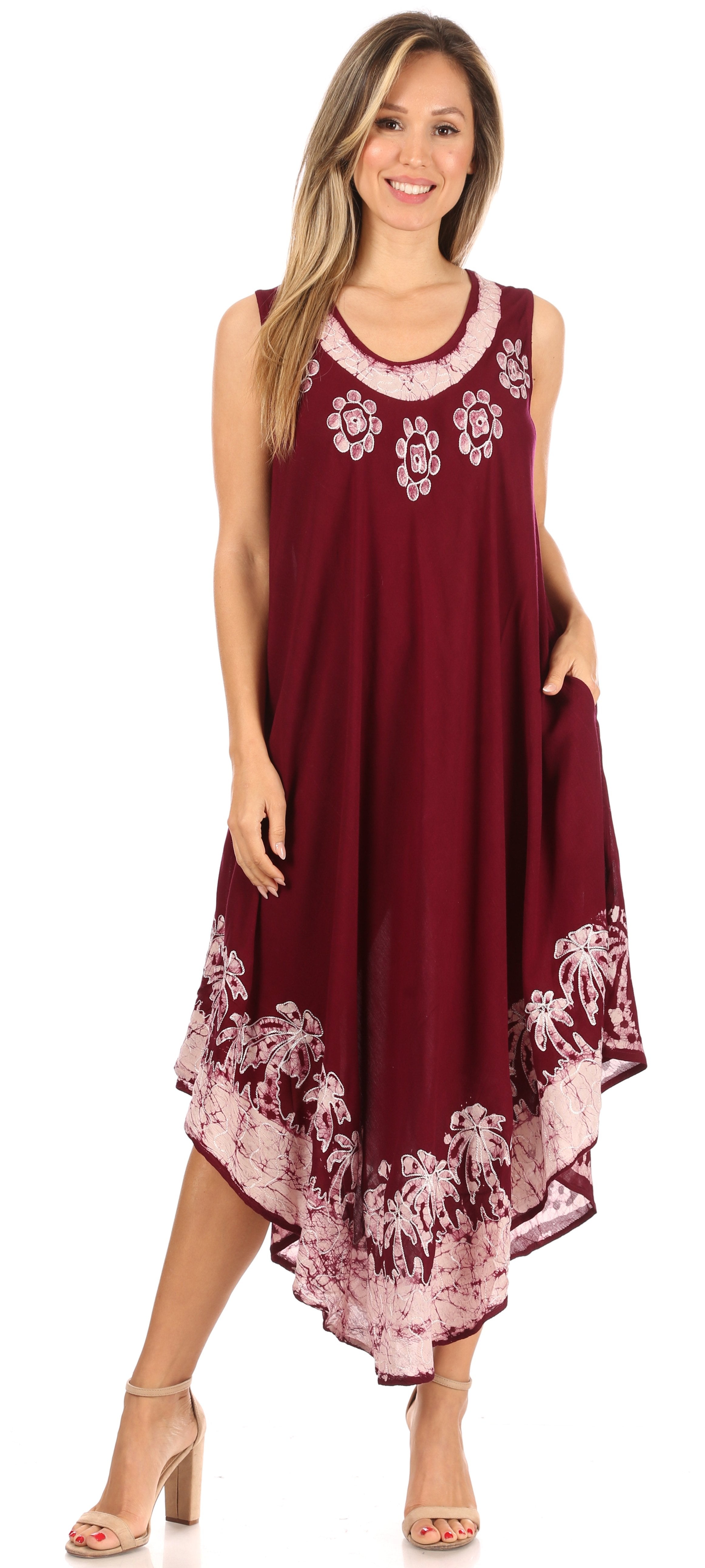 Woman wearing a burgundy dress with floral embroidery and patterns.