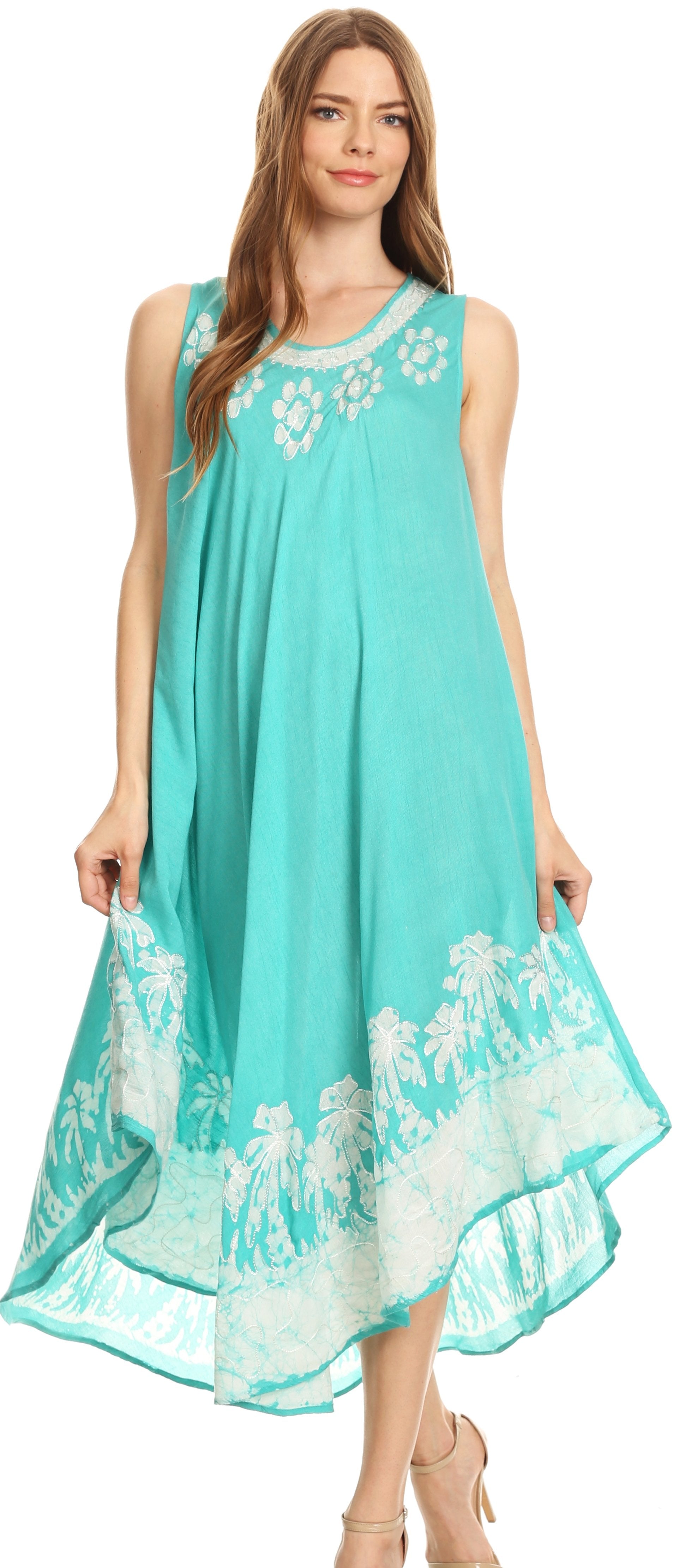 Woman wearing a turquoise dress with white floral patterns on a white background