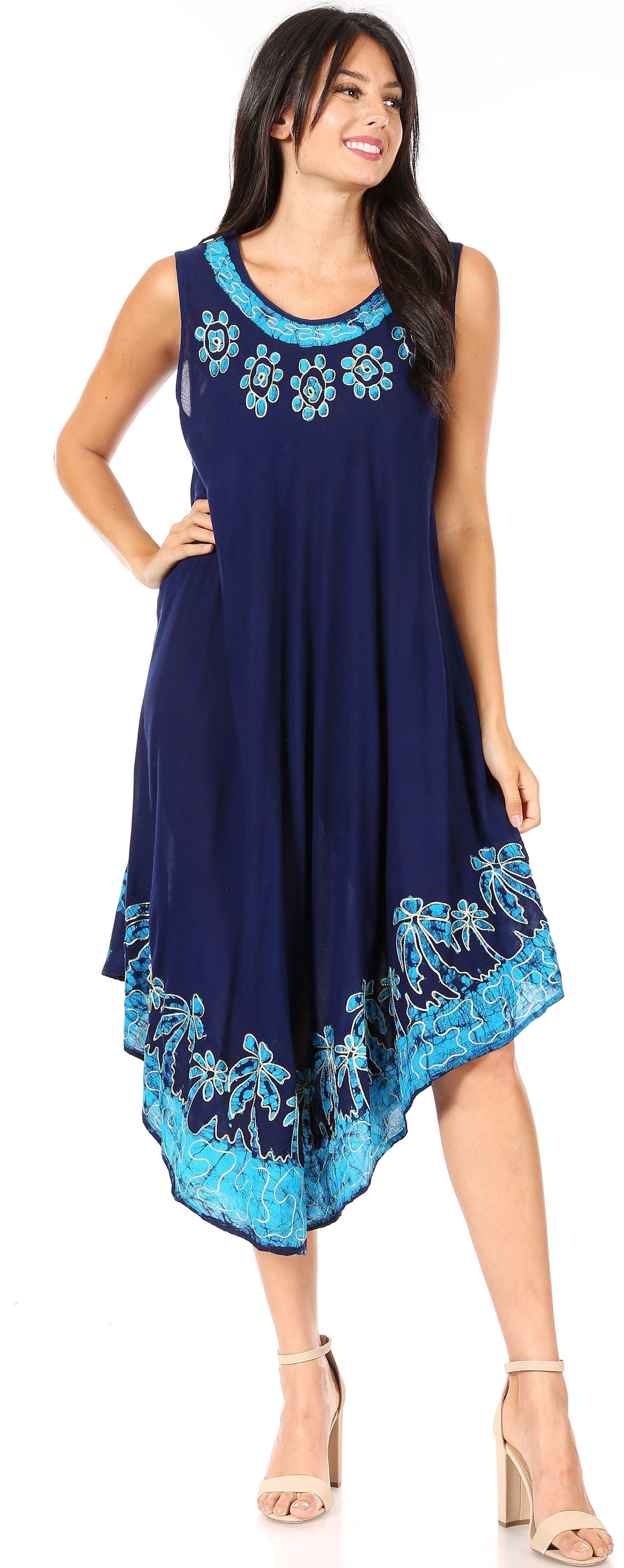 Woman wearing a navy dress with blue floral embroidery on a white background