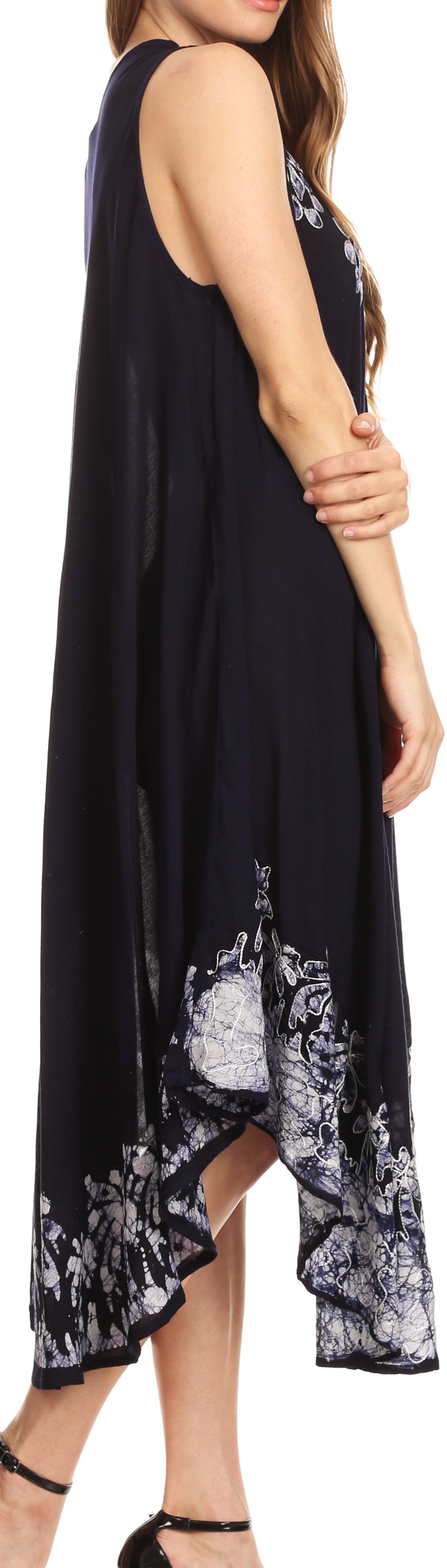 Woman wearing a black sleeveless dress with floral patterns.