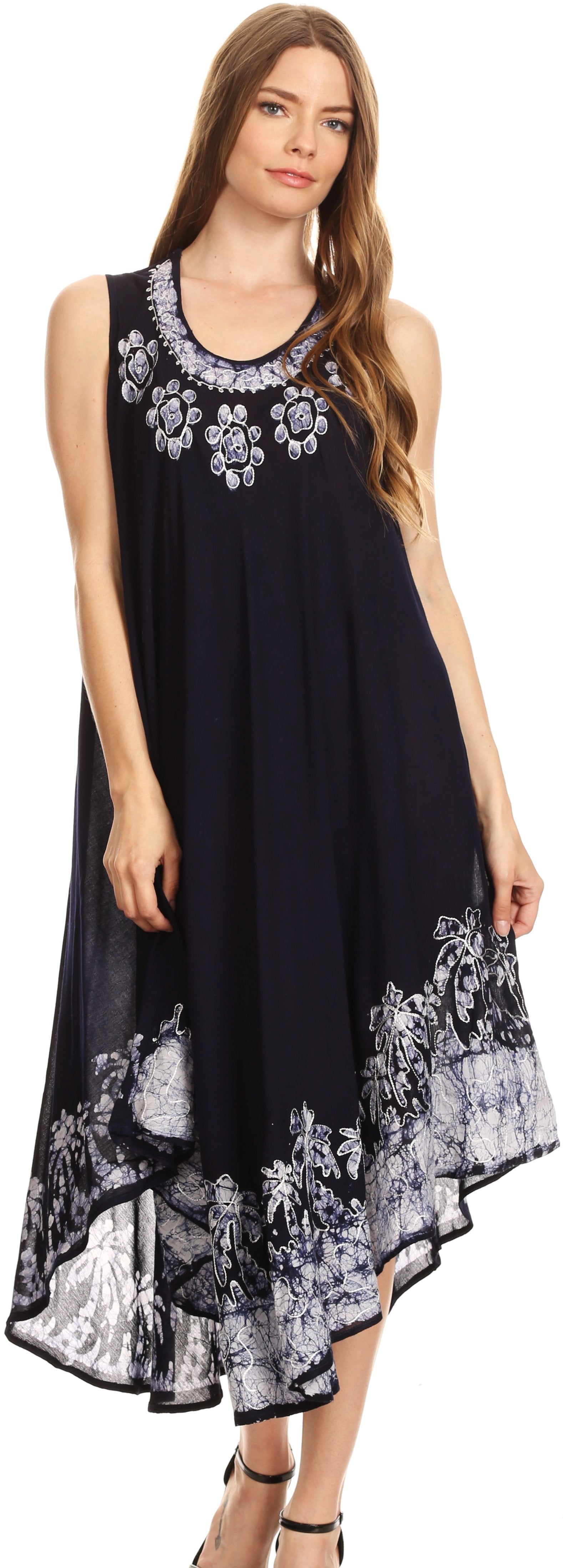 Woman wearing a black sleeveless dress with white floral patterns on a plain background