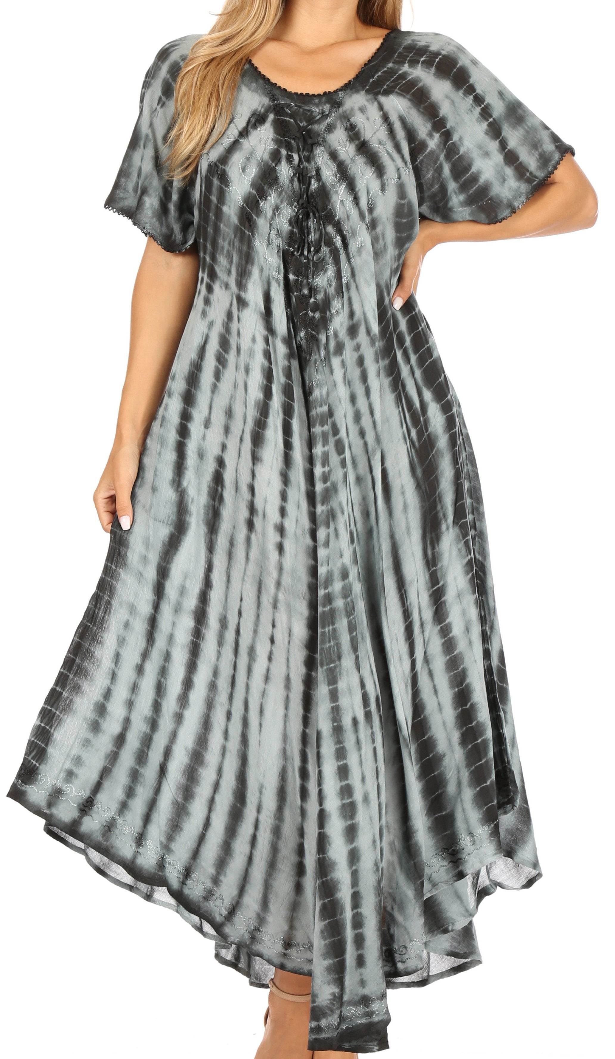 Woman wearing a tie-dye dress with a plain background