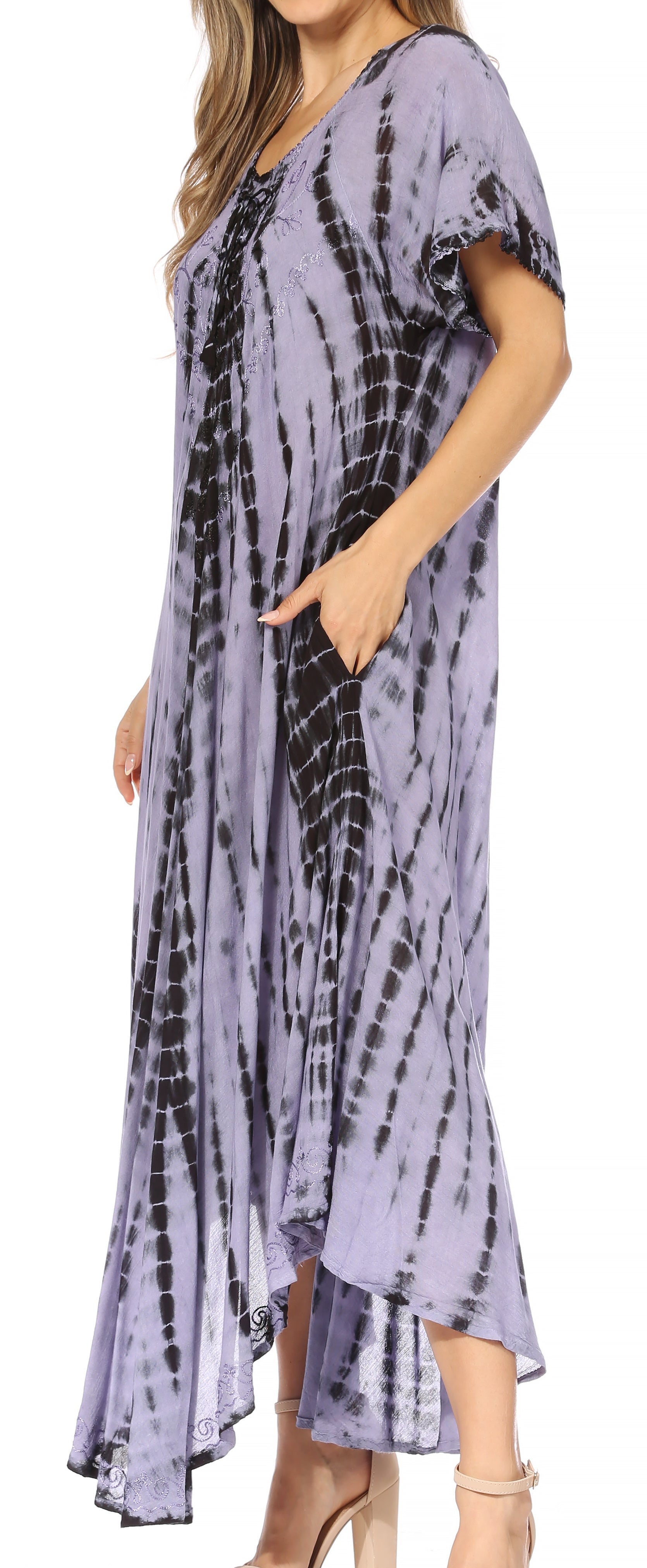 Woman wearing a tie-dye dress with a high-low hem in a store setting.