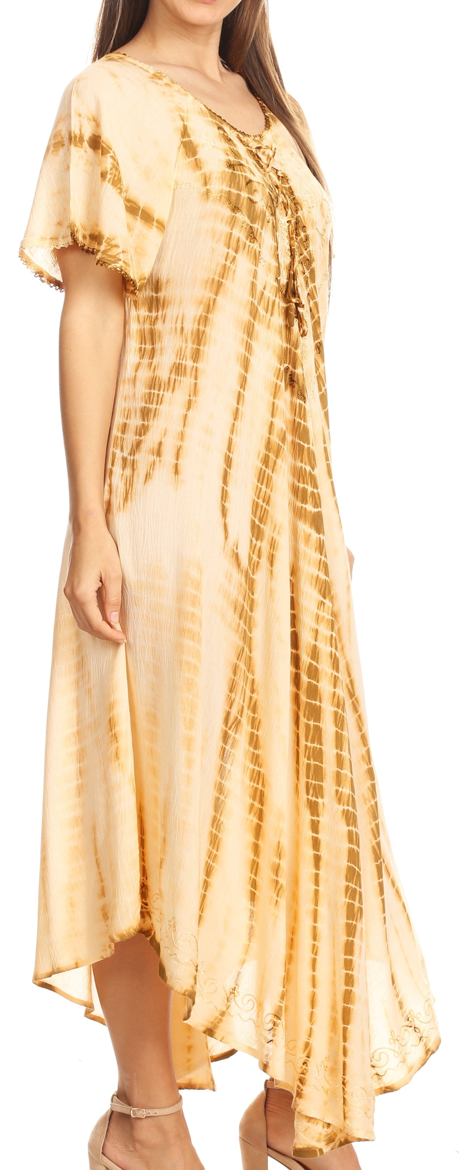 Woman wearing a yellow tie-dye dress with a plain background