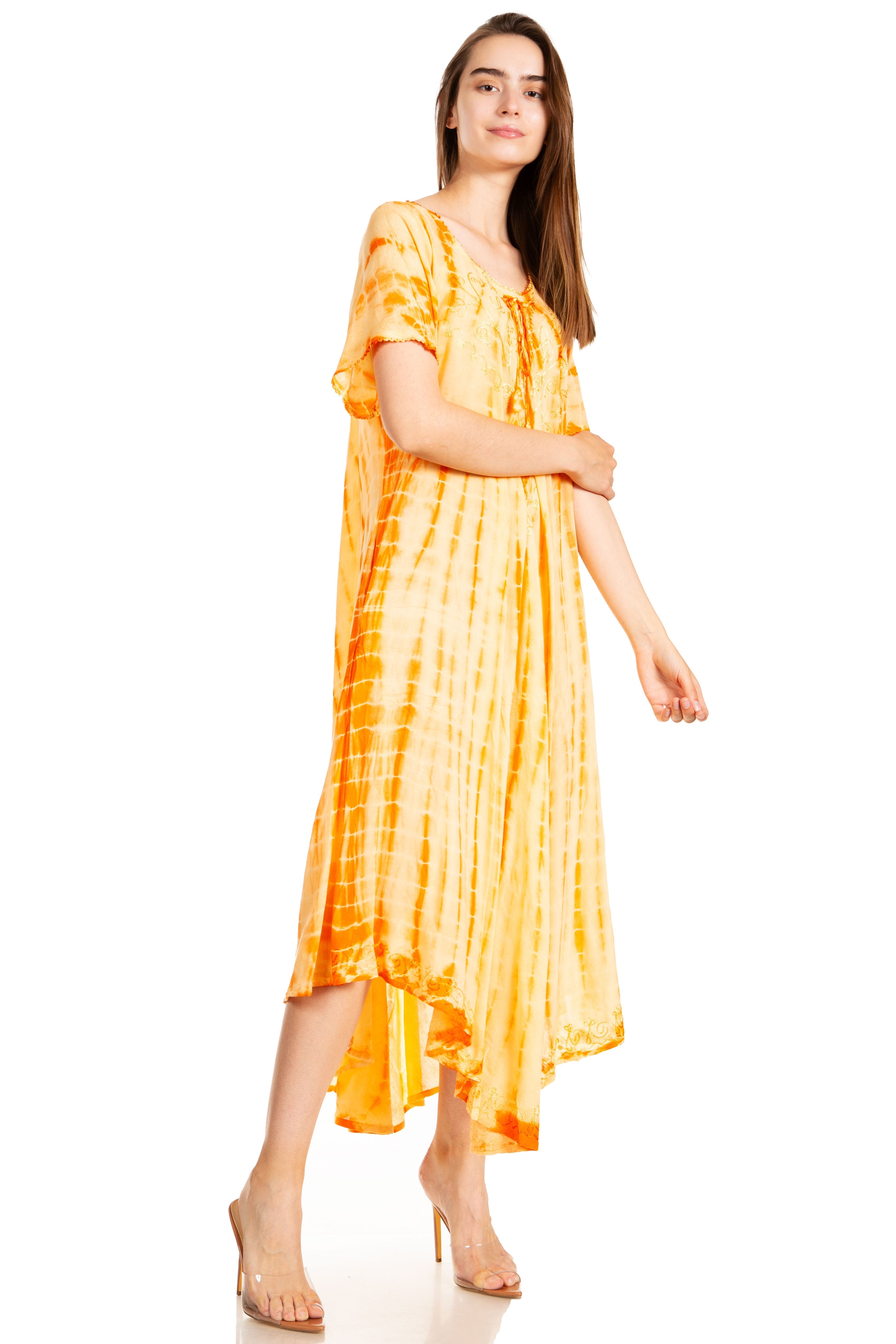 Woman wearing a yellow tie-dye dress on a white background