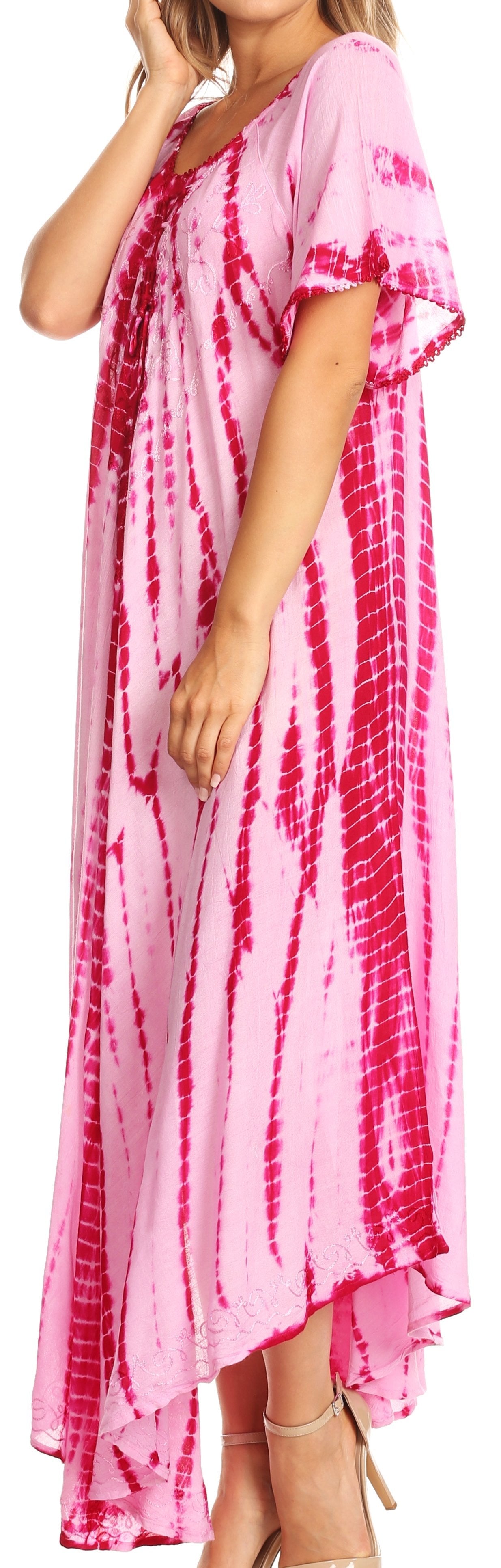 Woman wearing a pink and red tie-dye dress with a plain background