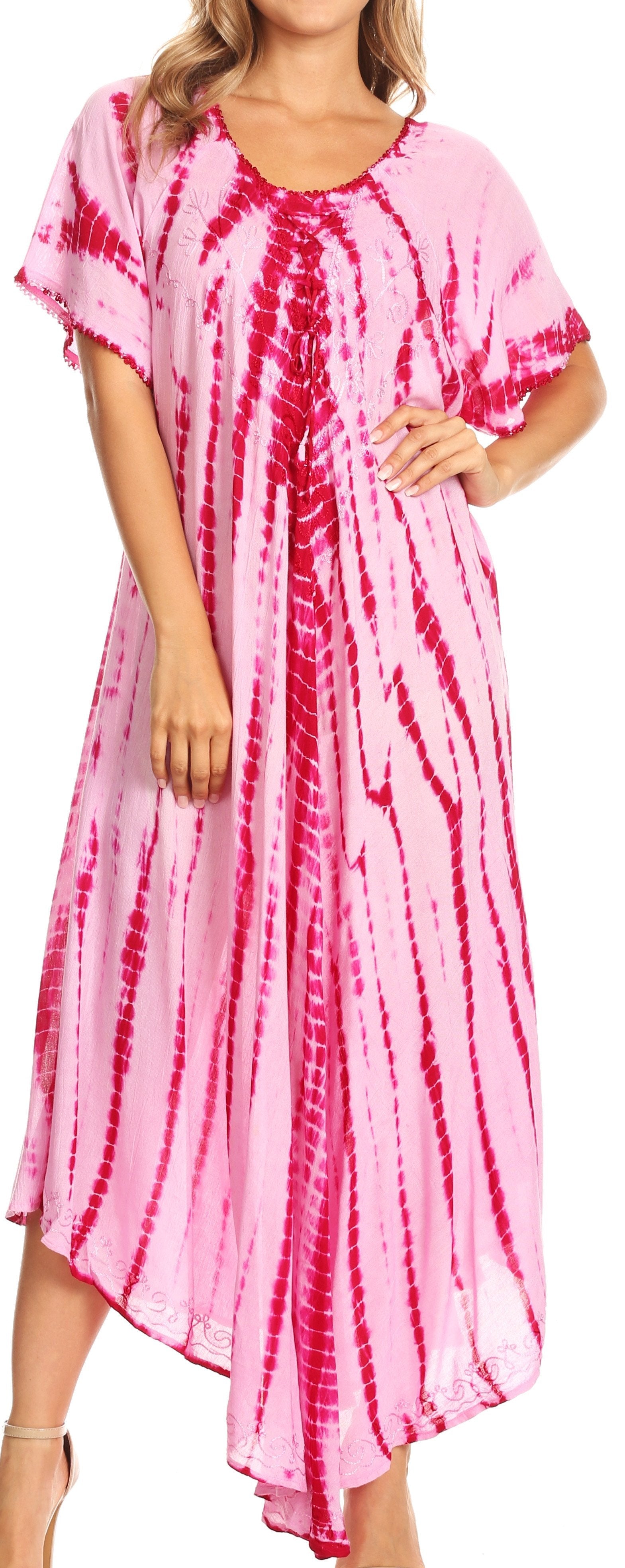 Woman wearing a pink and red tie-dye dress with a plain background