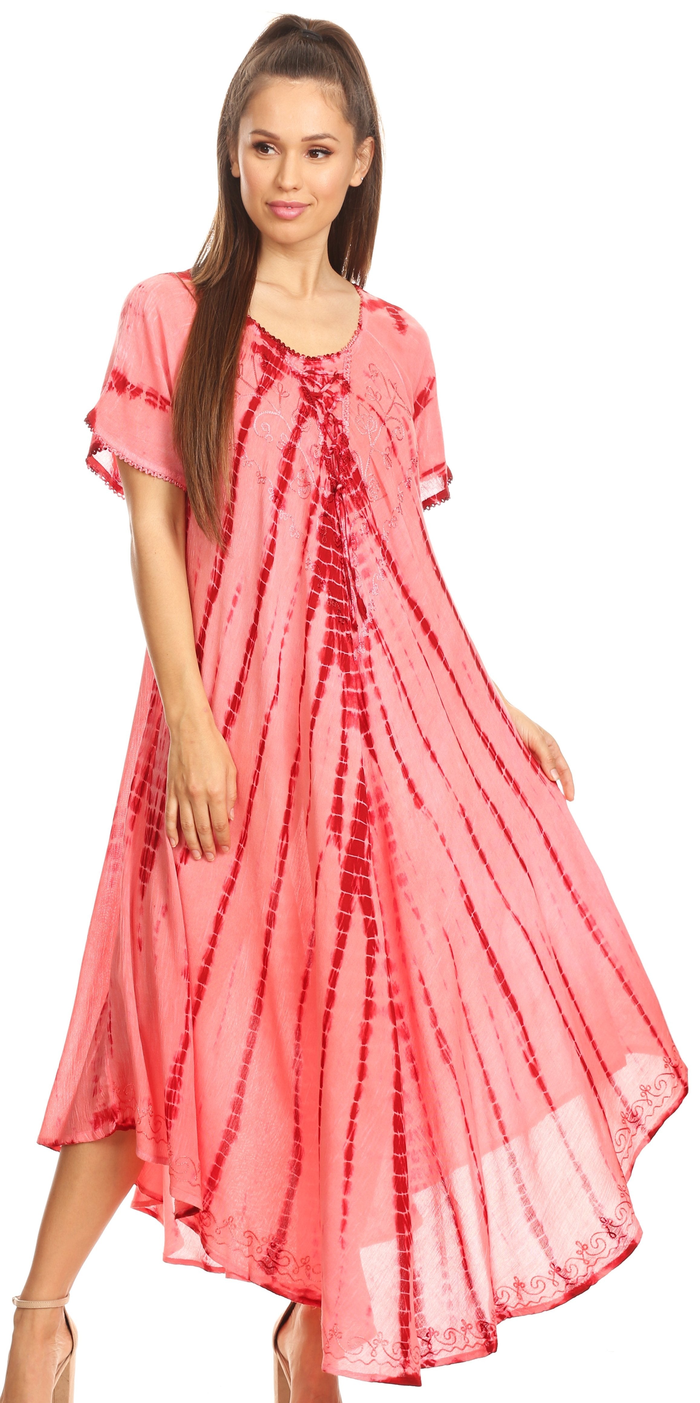 Woman wearing a pink tie-dye dress on a white background
