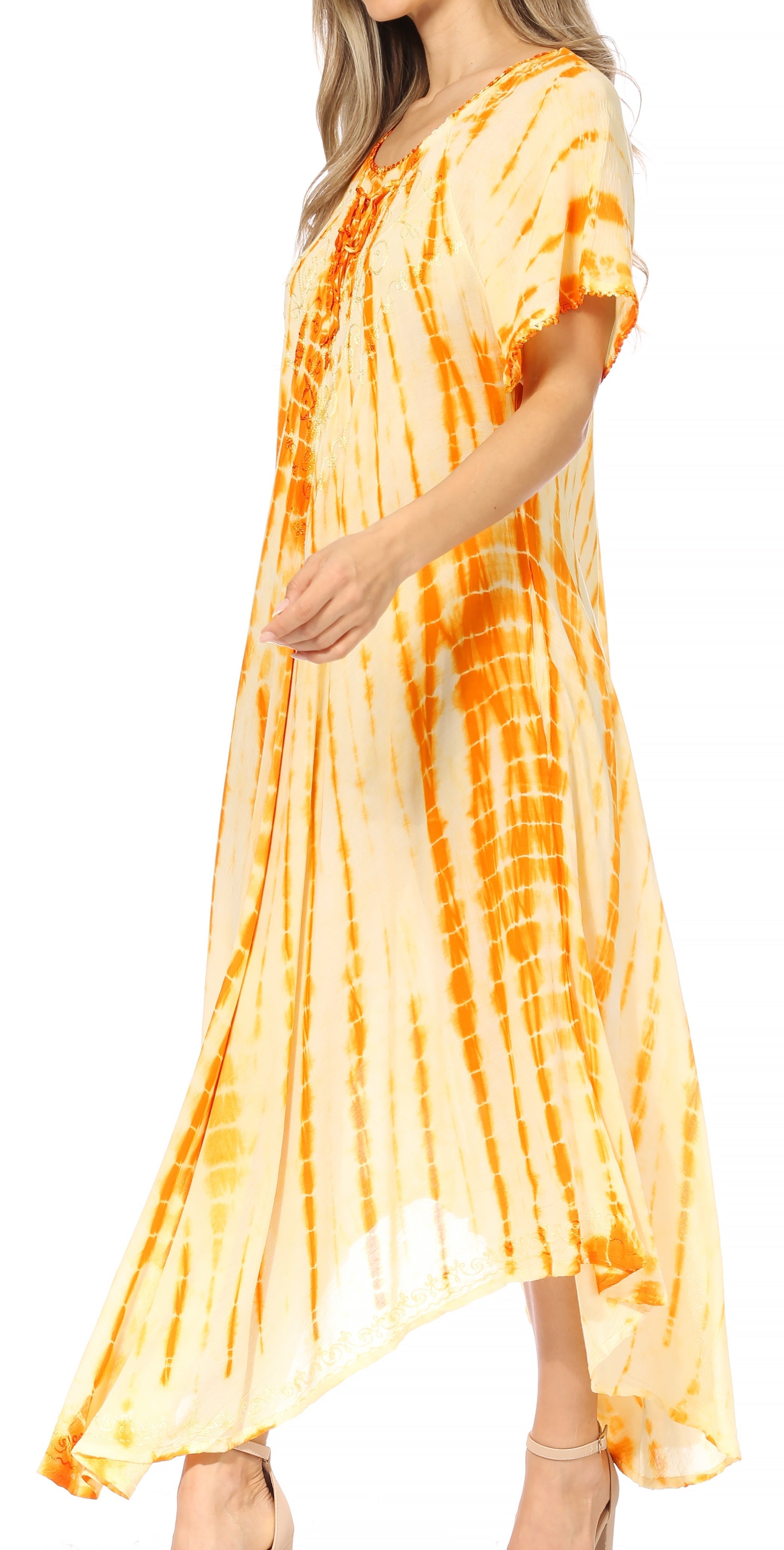 Woman wearing a tie-dye dress with a yellow and white pattern on a white background