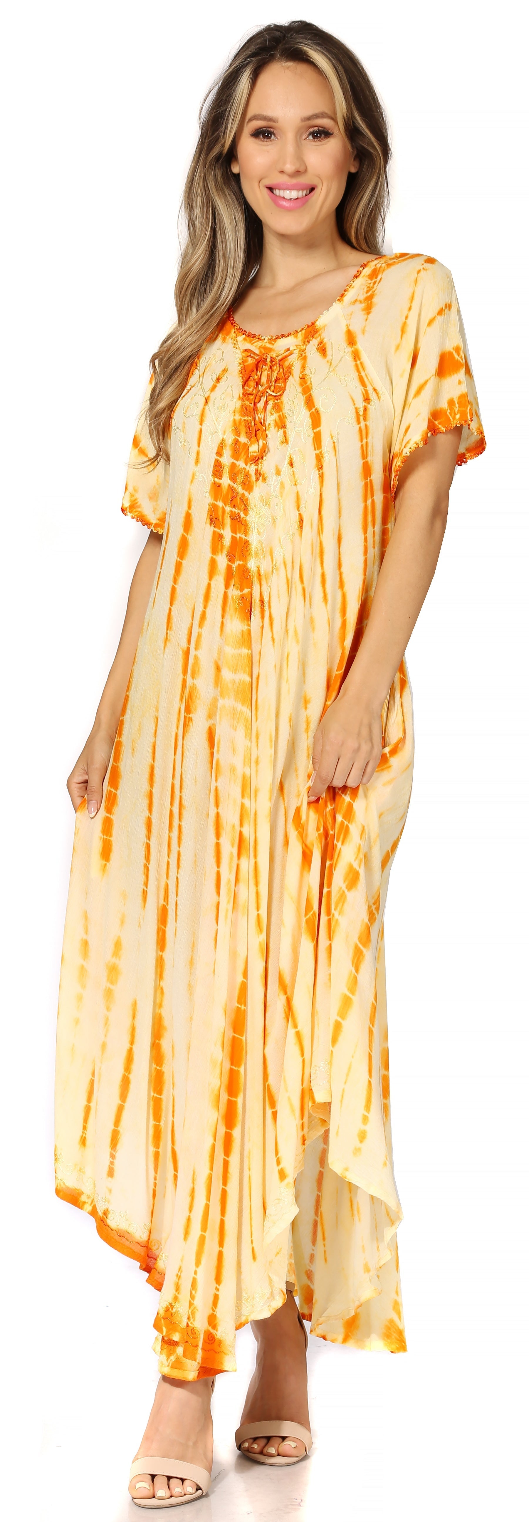 Woman wearing a tie-dye dress with orange and yellow pattern on a white background