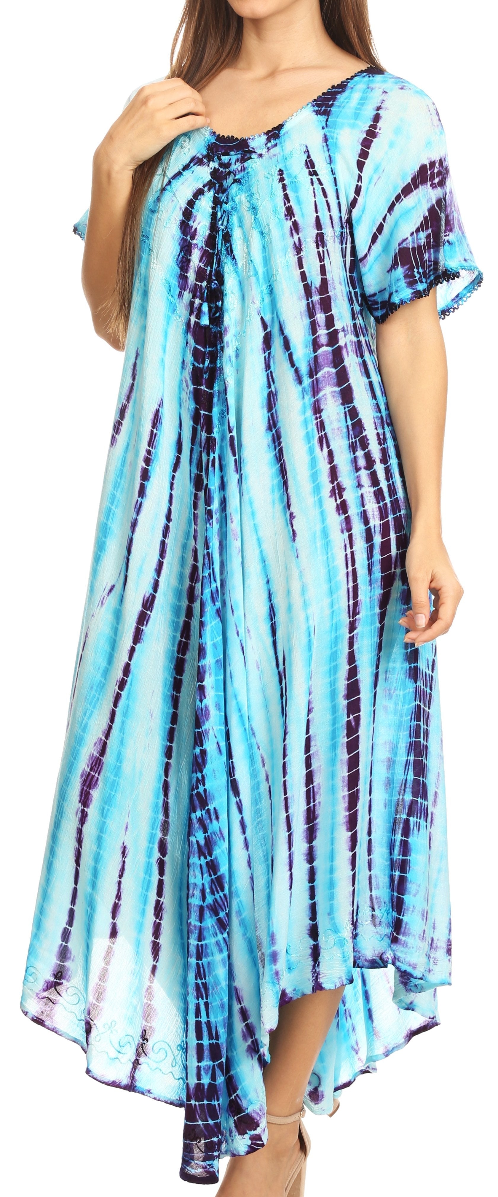 Woman wearing a blue and purple tie-dye dress with a plain background