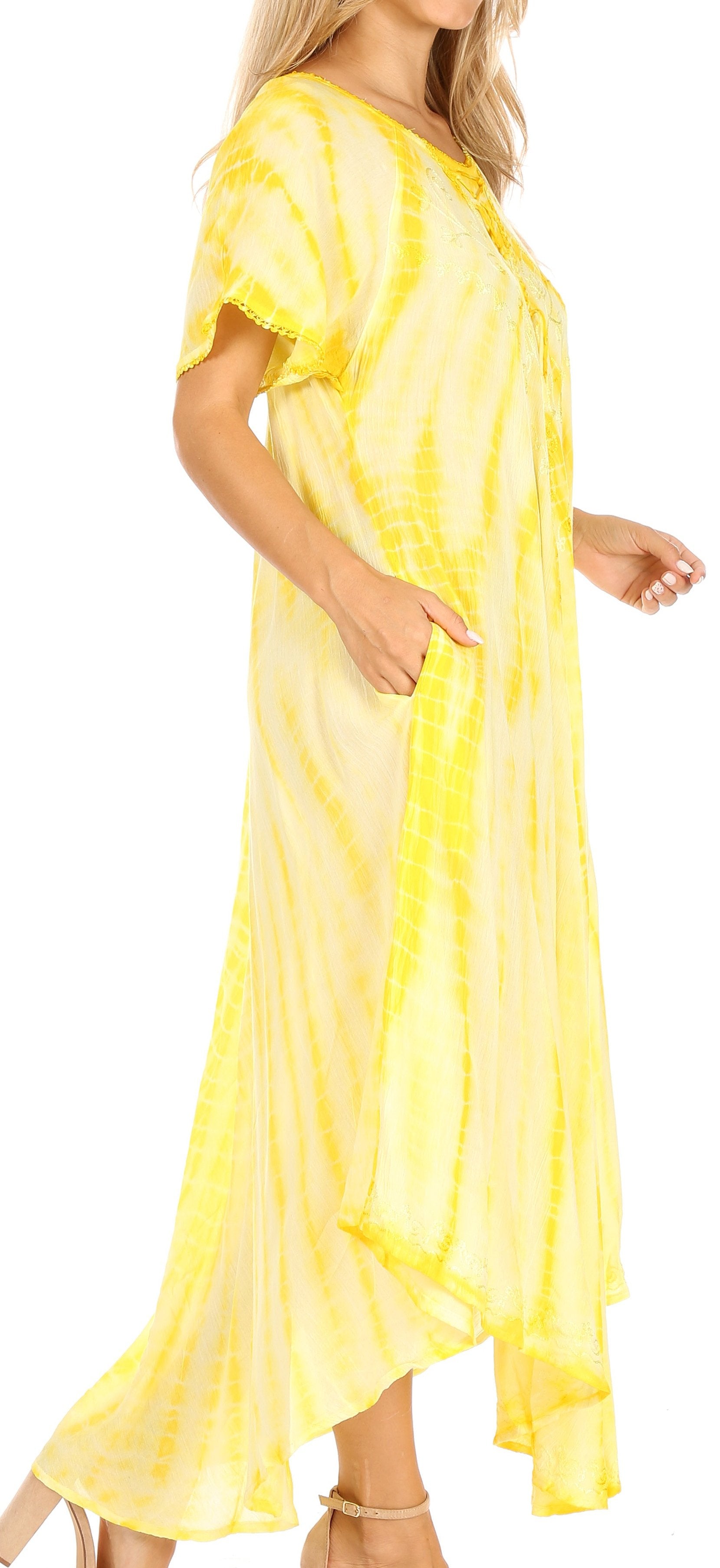 Woman wearing a yellow tie-dye dress with a plain background