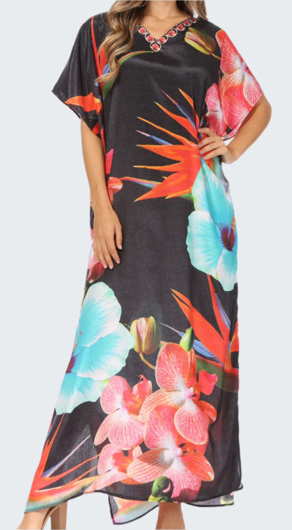 Black dress with colorful floral pattern worn by a model on a white background