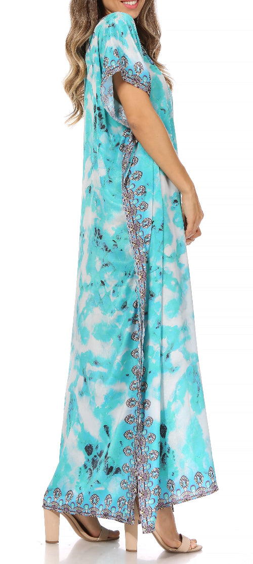 Woman wearing a turquoise dress with floral patterns on a white background