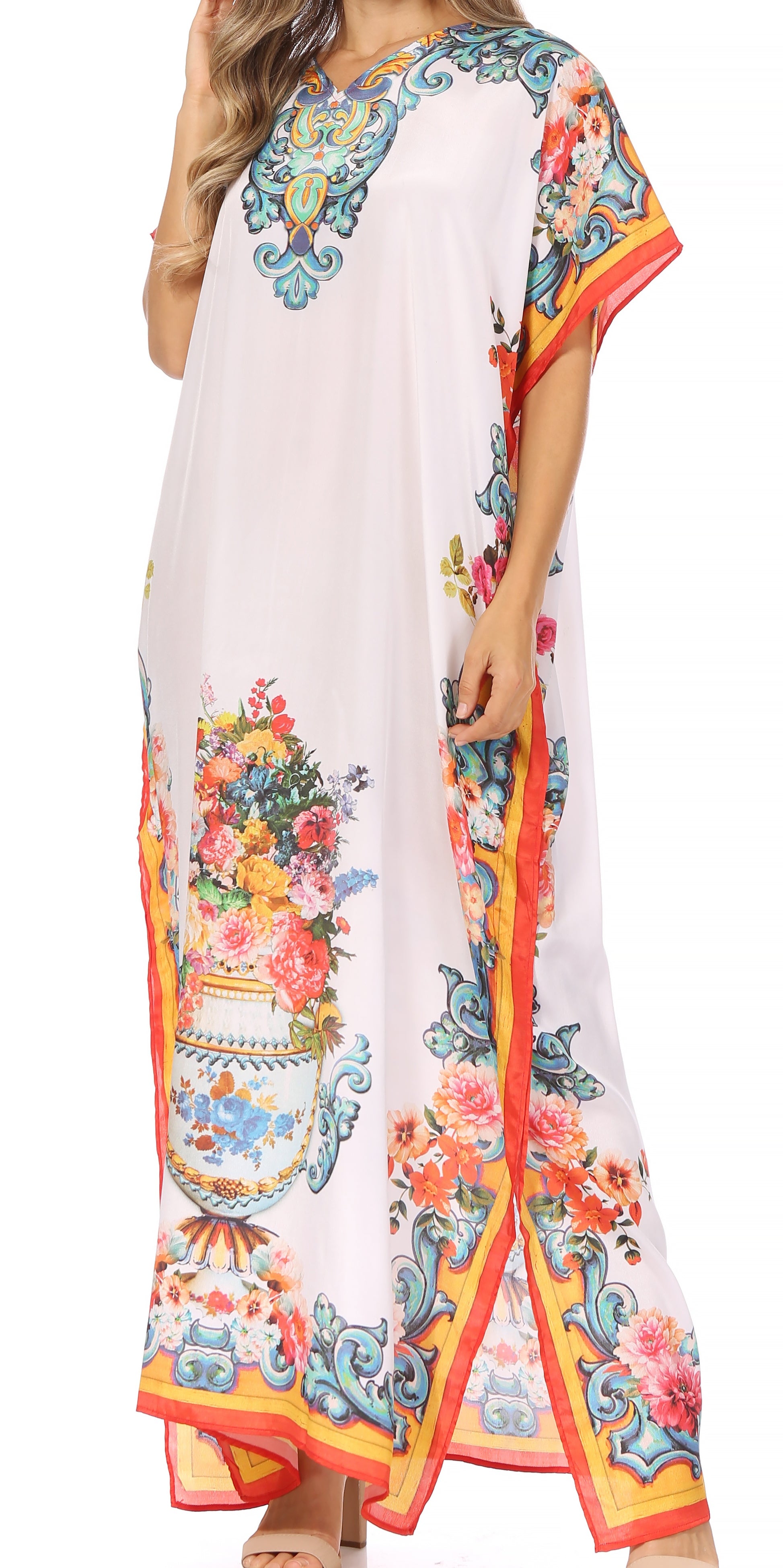 Woman wearing a long, floral-patterned dress with a colorful border on a white background