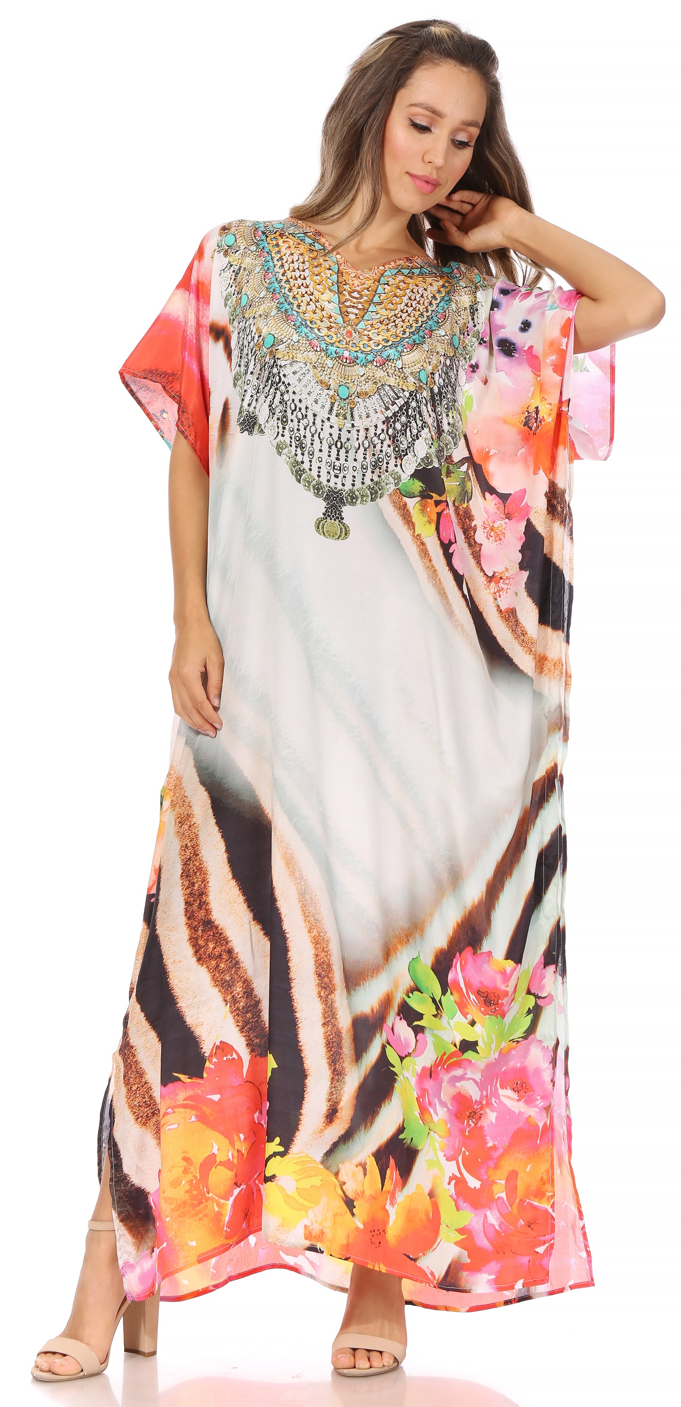 Woman wearing a colorful dress with floral patterns and bead embellishments on a white background