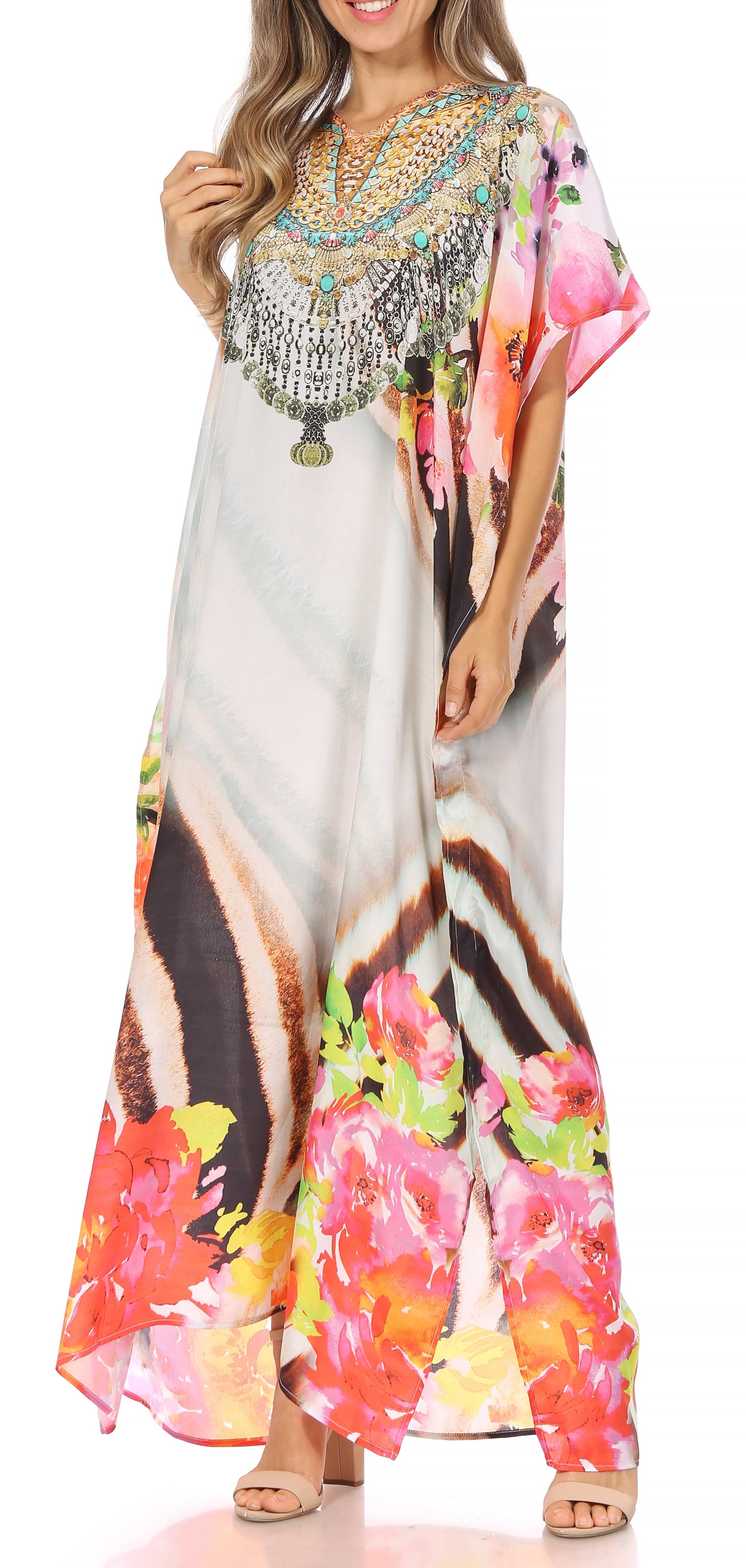 Woman wearing a colorful floral dress with embellishments on a white background