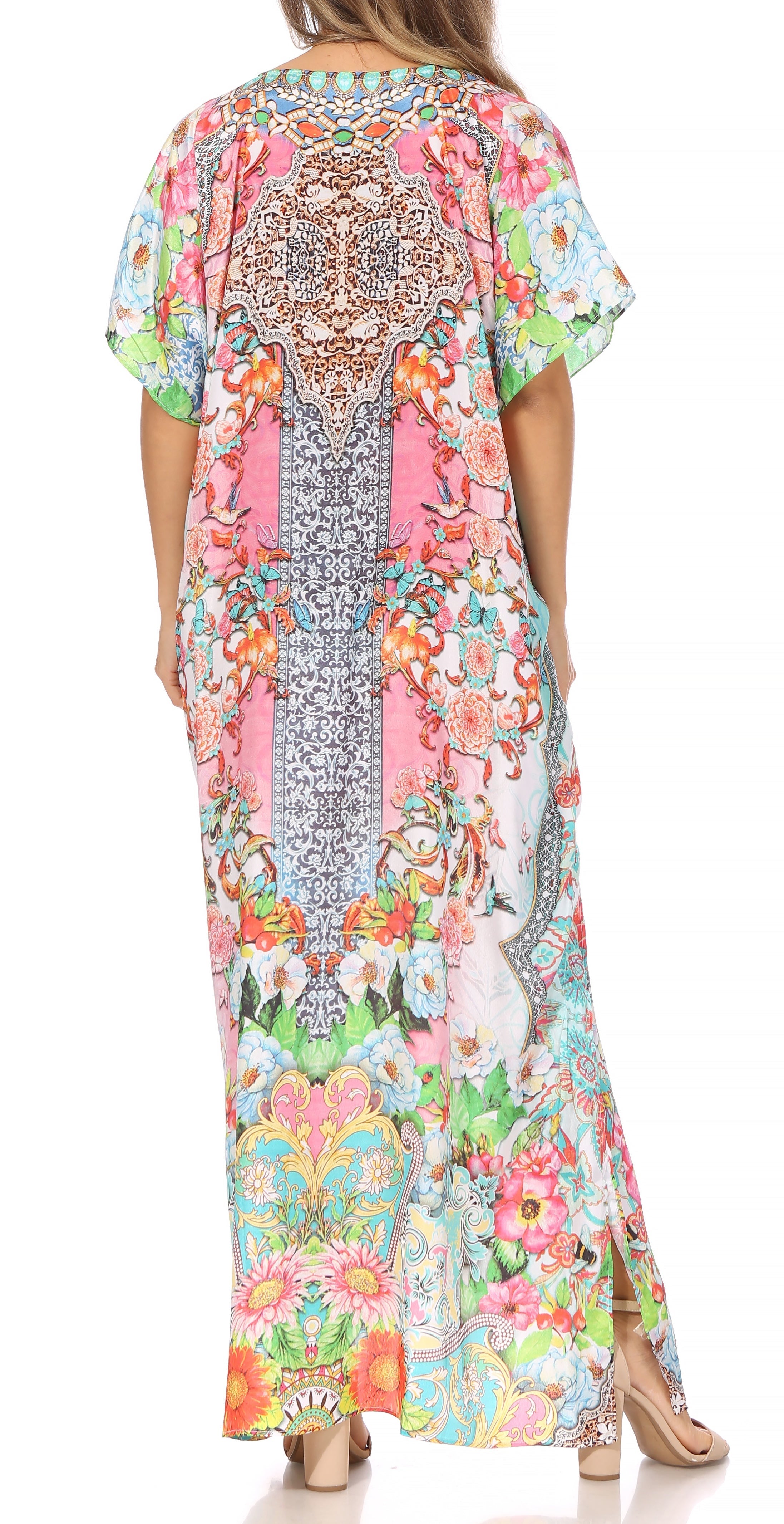 Woman wearing a colorful floral dress with a patterned back on a white background