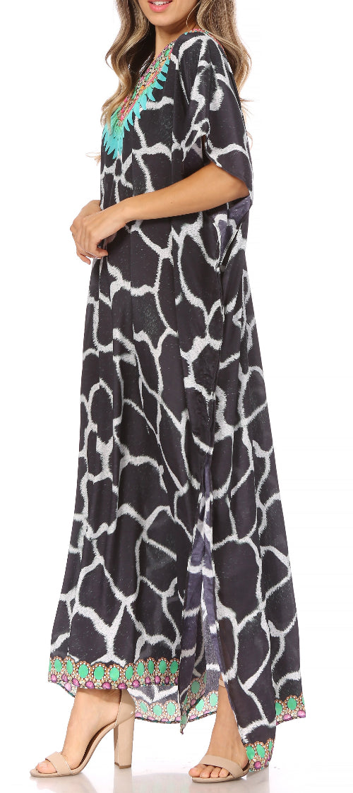 Woman wearing a long black and white patterned dress with colorful trim on a white background
