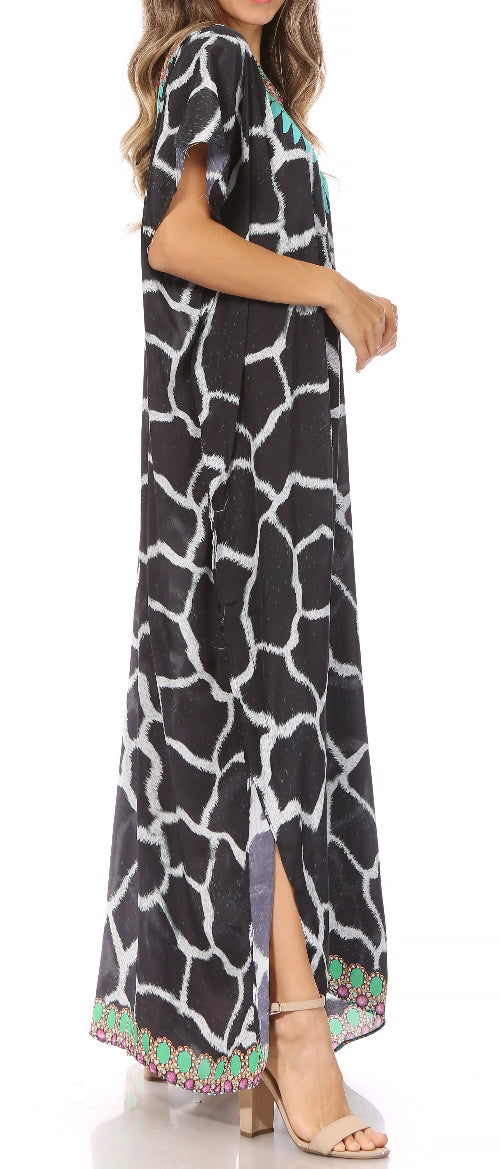 Woman wearing a black and white patterned dress with colorful trim on a white background