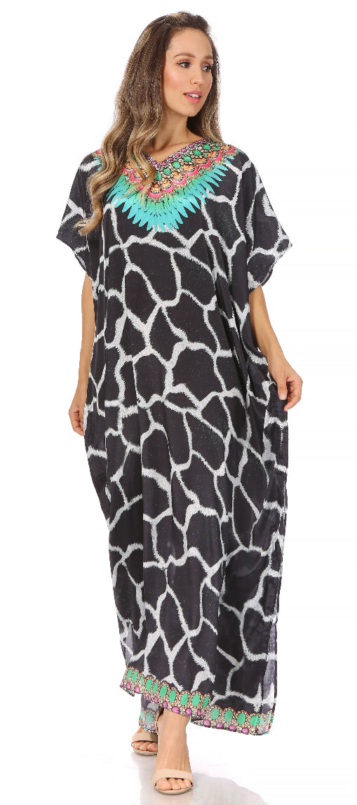 Woman wearing a black and white patterned dress with colorful embellishments on a white background