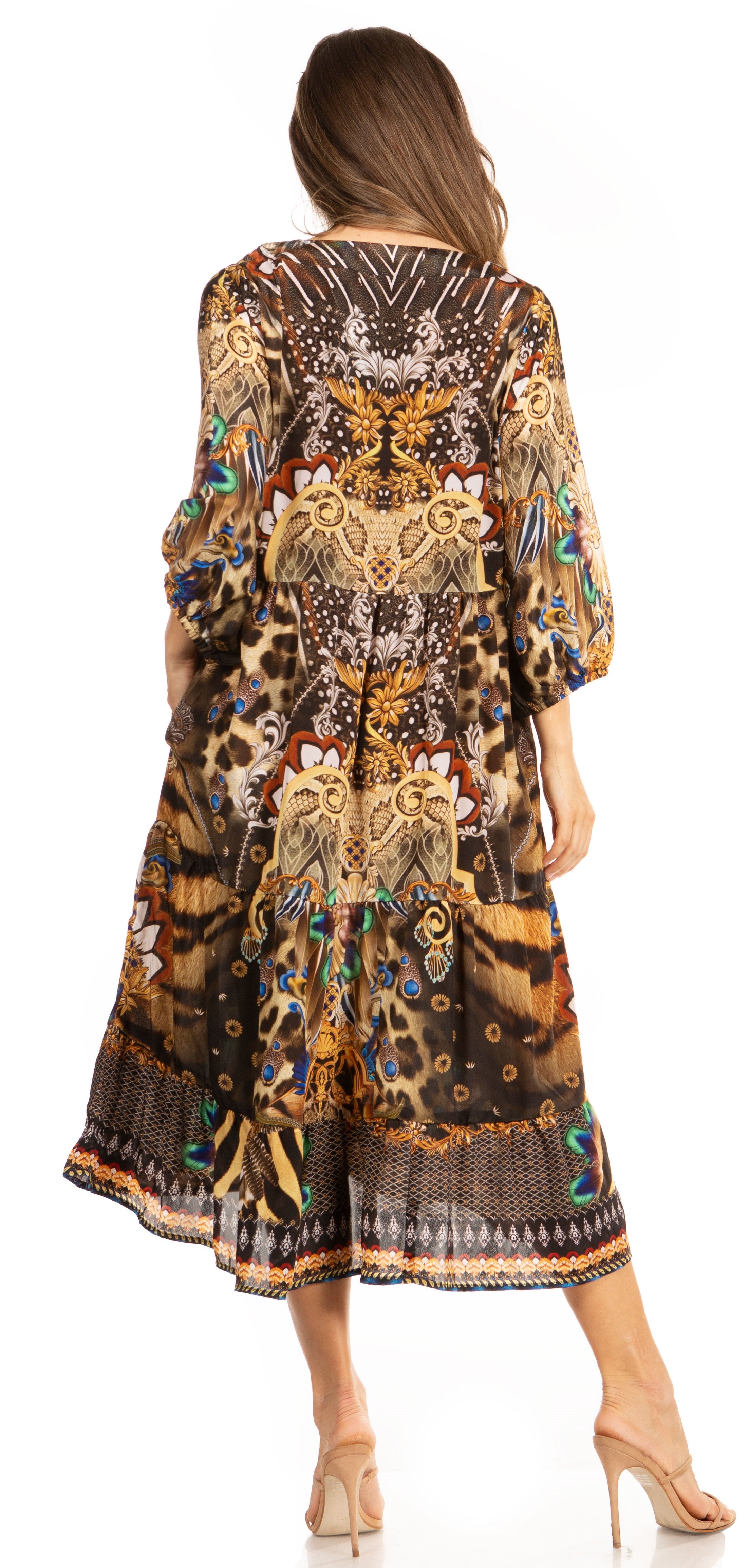 Woman wearing a long, patterned dress with intricate designs on a white background