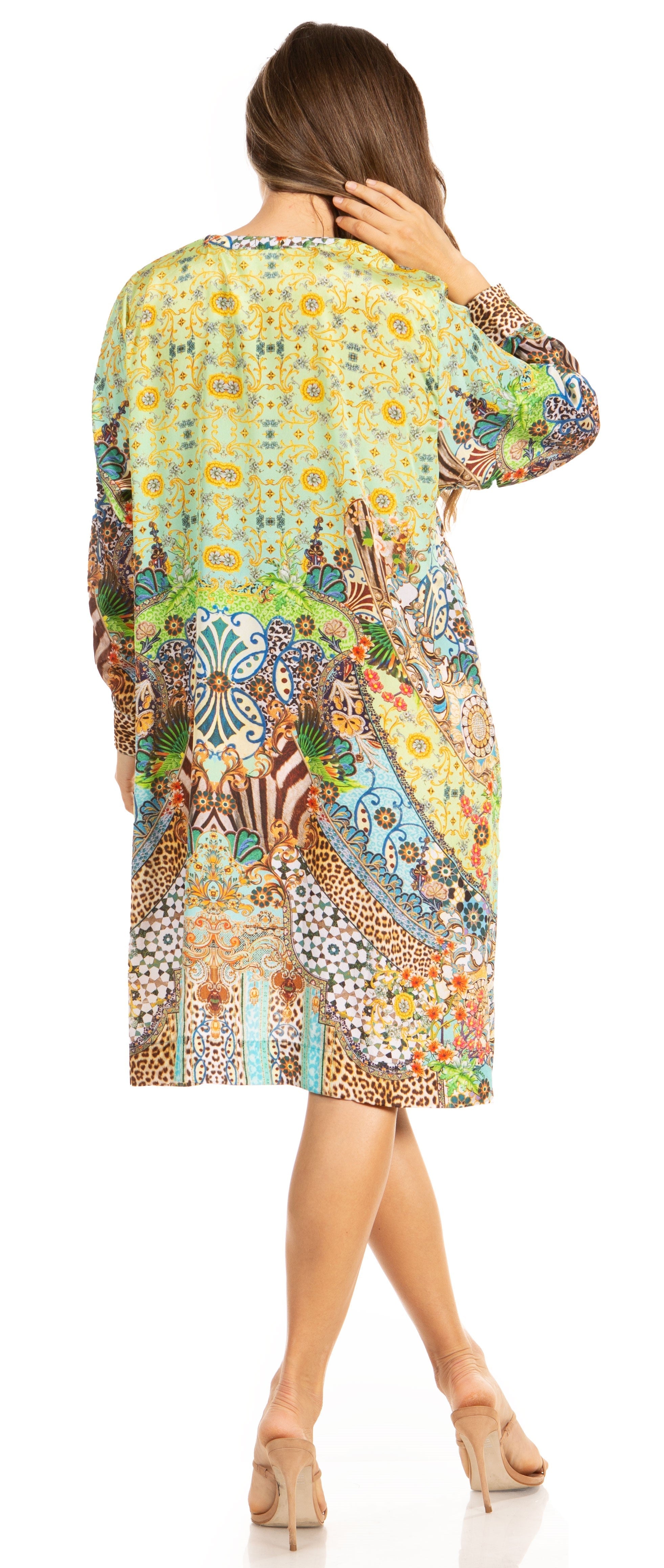 Woman wearing a colorful patterned dress on a white background