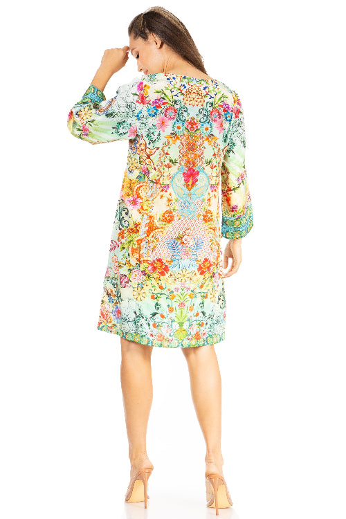 Woman wearing a colorful floral dress on a white background