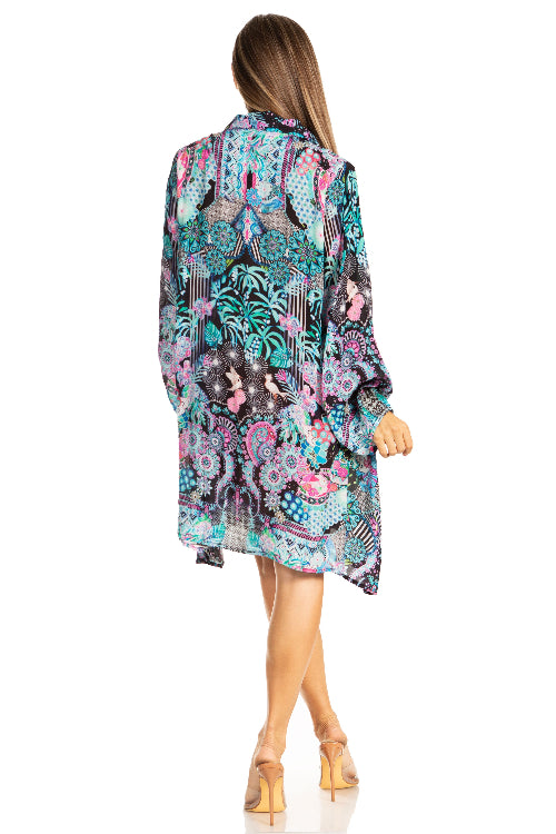 Woman wearing a colorful patterned dress on a white background
