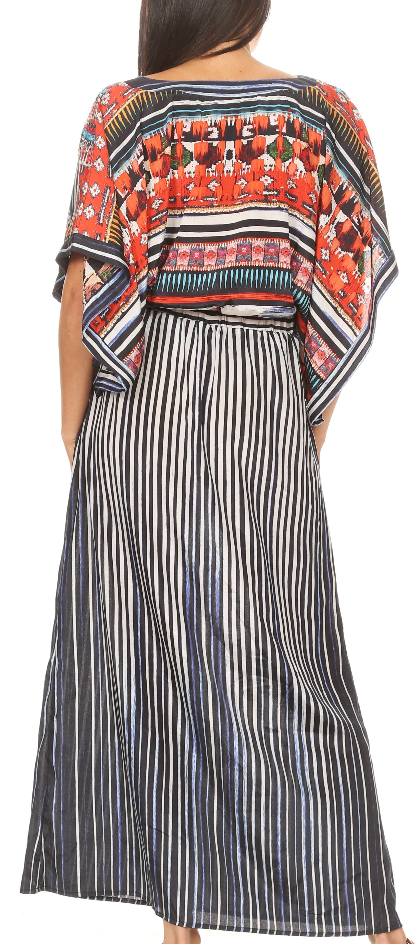 Woman wearing a long, patterned dress with a colorful top and black and white striped skirt.