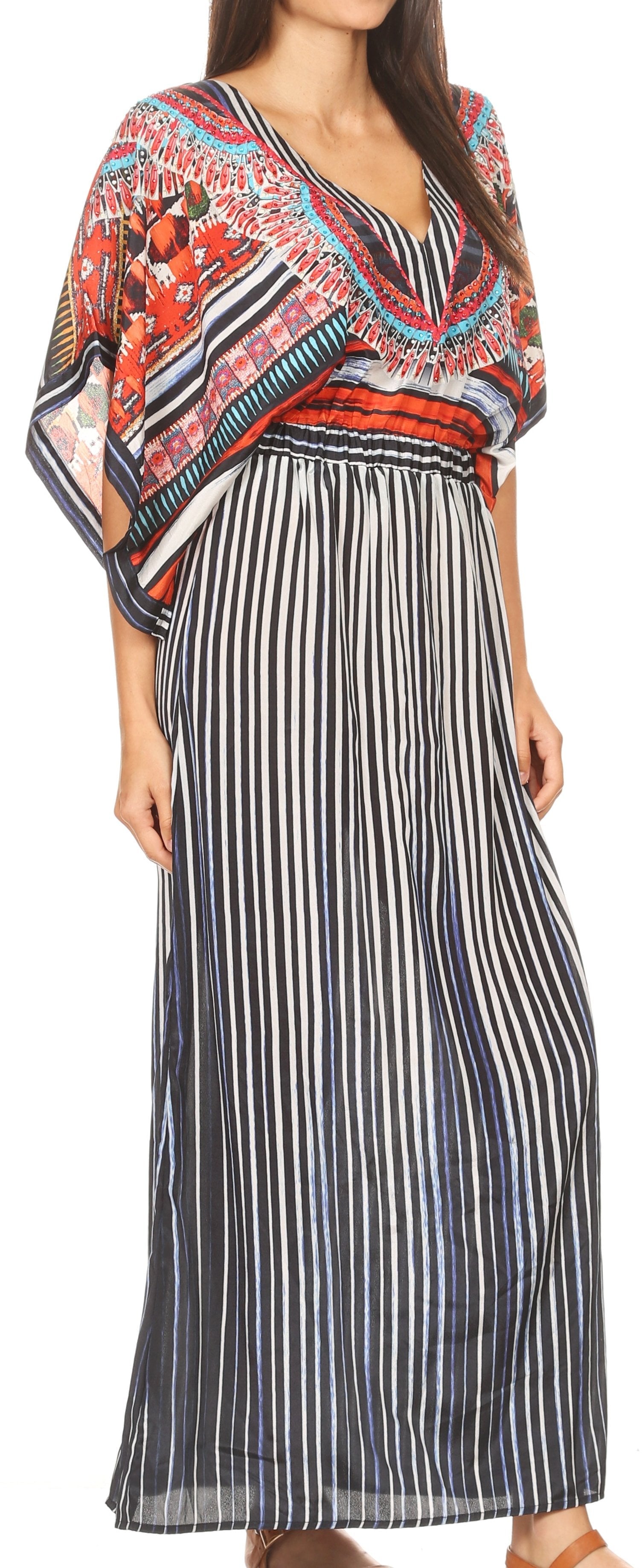 Woman wearing a colorful patterned top with a long black and white striped skirt.