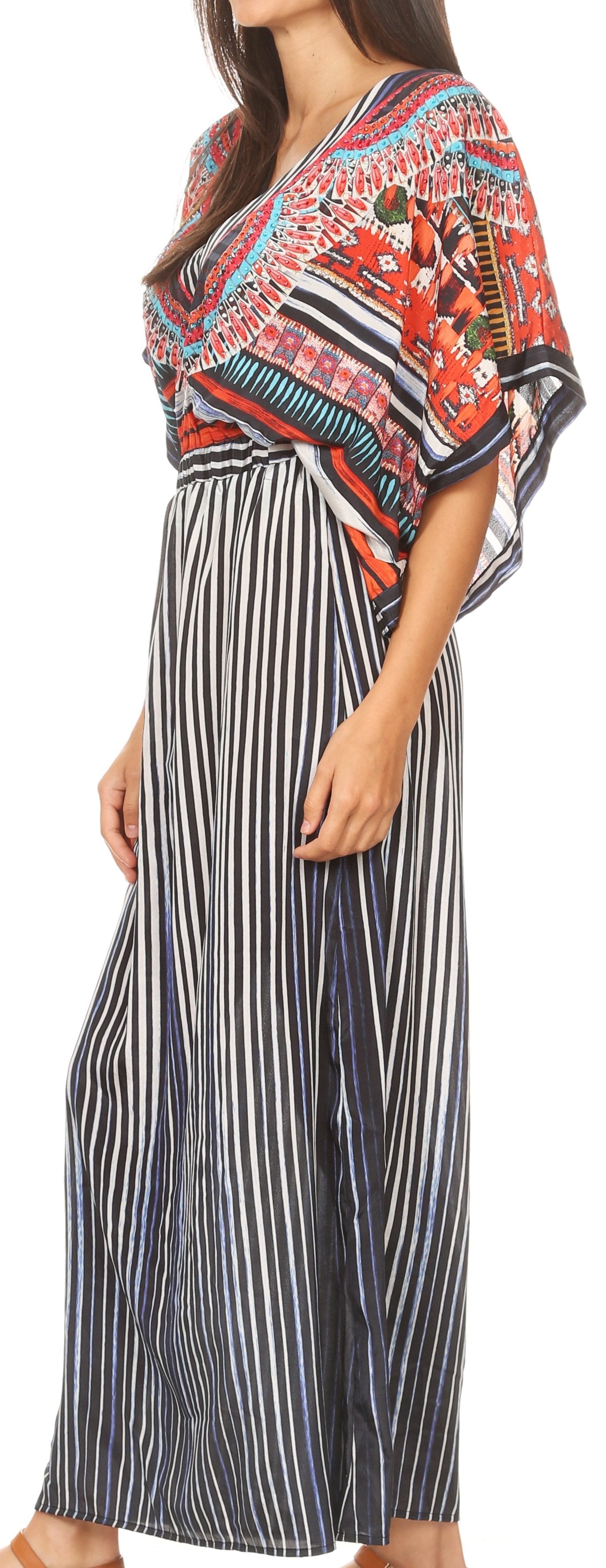 Woman wearing a colorful patterned top and black and white striped pants.