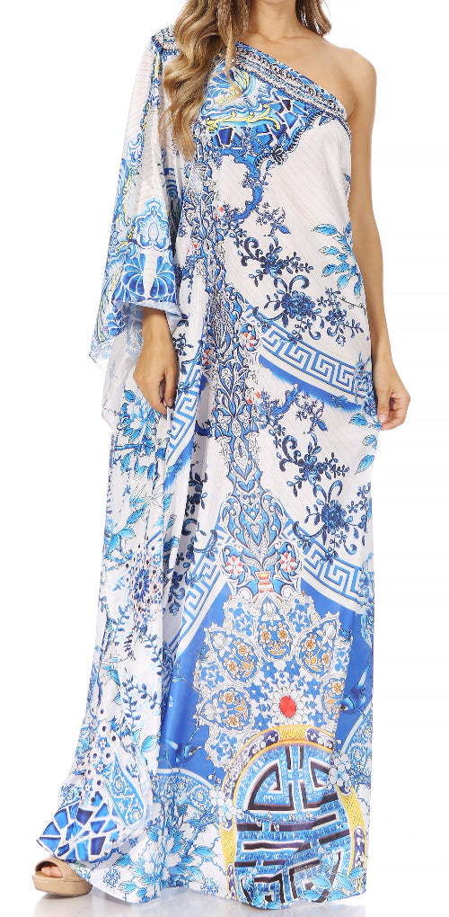 Woman wearing a long, one-shoulder dress with a blue and white pattern on a white background