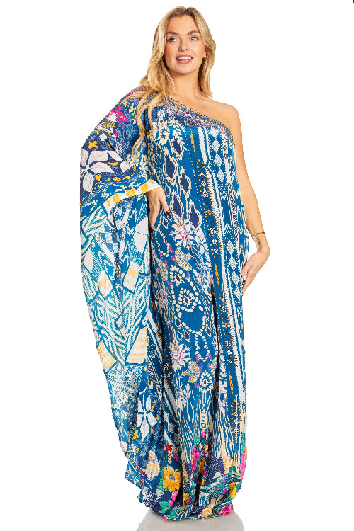 Woman wearing a blue floral one-shoulder dress on a white background
