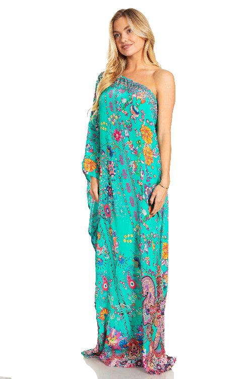 Woman wearing a floral one-shoulder dress on a white background