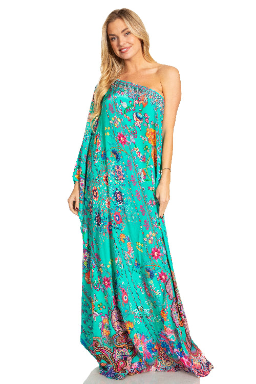 Woman wearing a colorful strapless dress with floral and paisley patterns on a white background