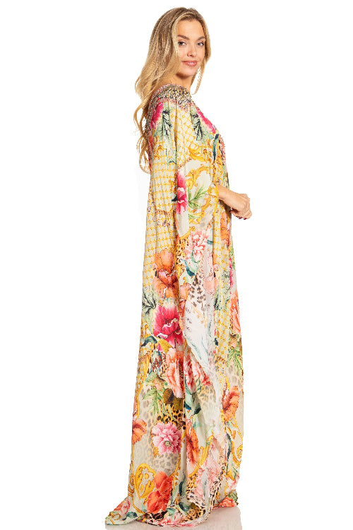 Woman wearing a floral maxi dress on a white background