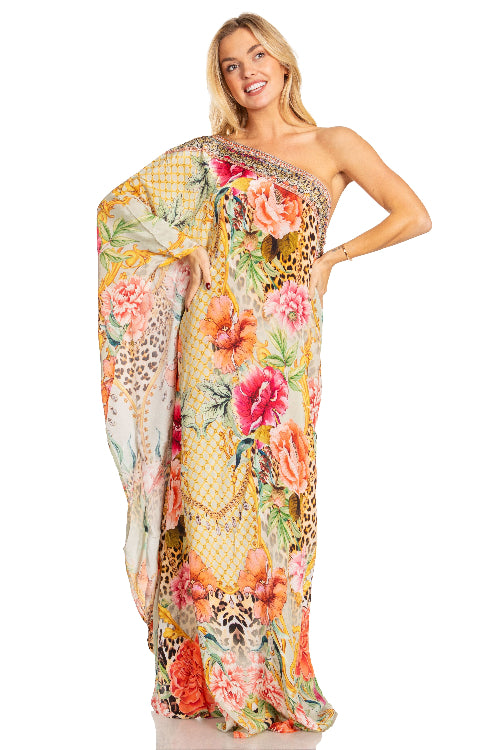 Woman wearing a floral one-shoulder dress on a white background