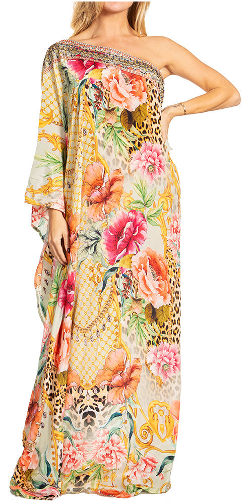 Woman wearing a floral one-shoulder dress with colorful patterns on a white background