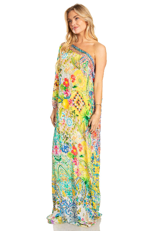 Woman wearing a colorful floral one-shoulder dress on a white background
