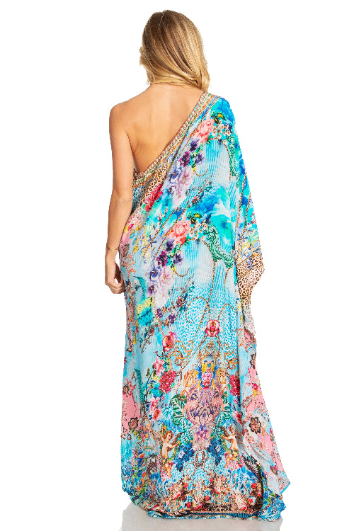 Woman wearing a colorful floral dress on a white background