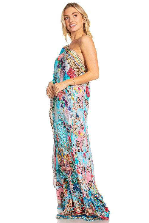Woman wearing a colorful floral one-shoulder dress on a white background