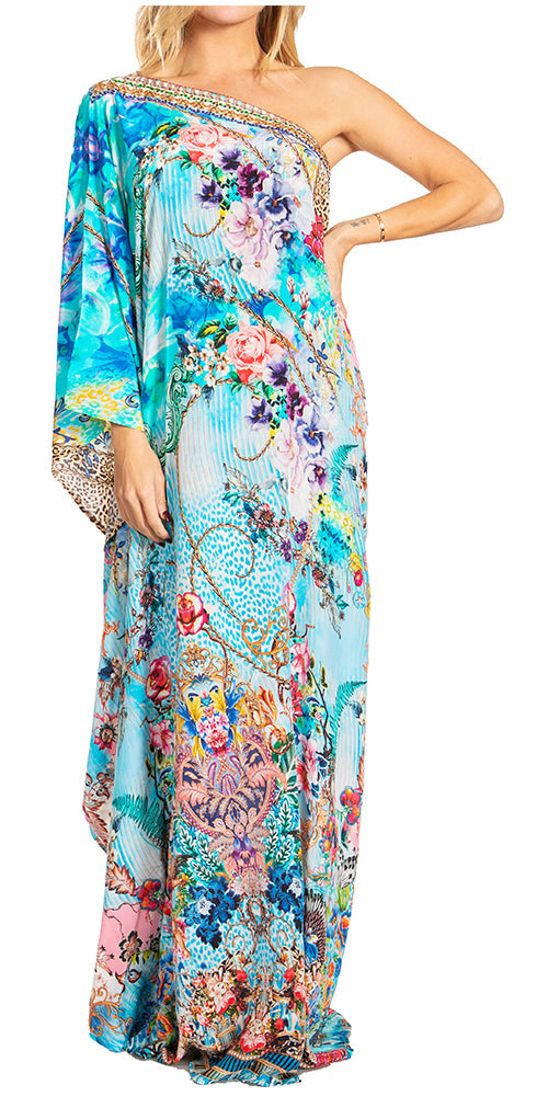 Woman wearing a colorful floral one-shoulder dress on a white background