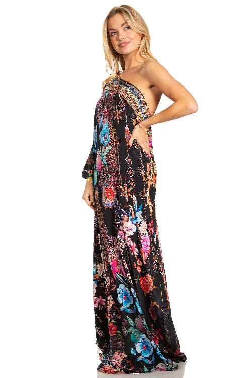 Woman wearing a floral one-shoulder dress on a white background