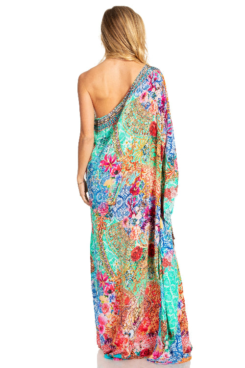 Woman wearing a colorful floral dress on a white background