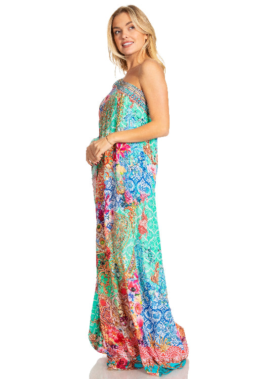 Woman wearing a colorful floral dress on a white background